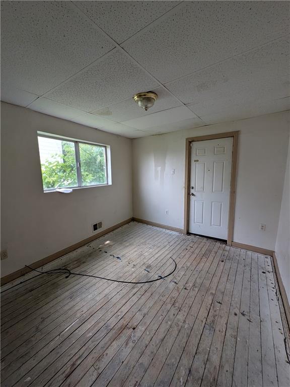 709-711 Fruit Way McKees Rocks, PA 15136 - Photo 9 of 37 an empty room with wooden floor and windows