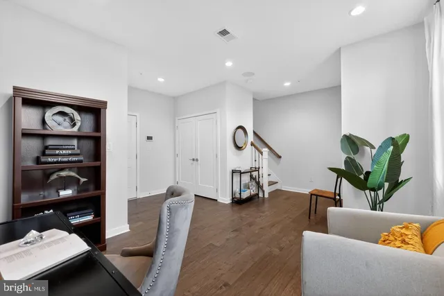 a living room with furniture gym equipment and a potted plant