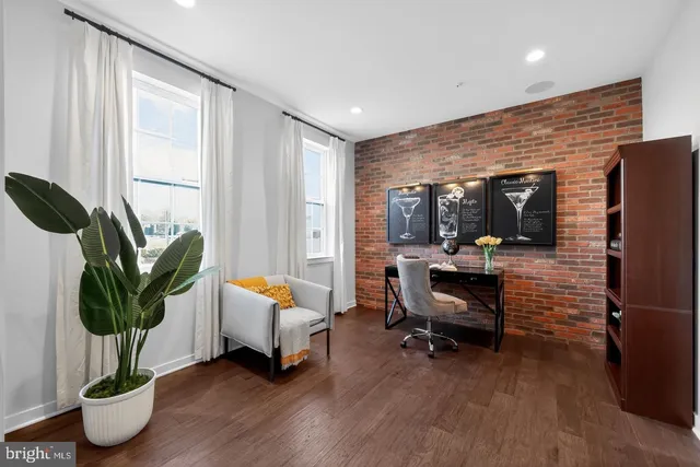 a living room with furniture floor to ceiling window and potted plant