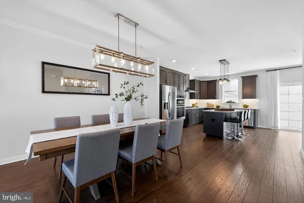 a view of a dining room with furniture wooden floor and kitchen view