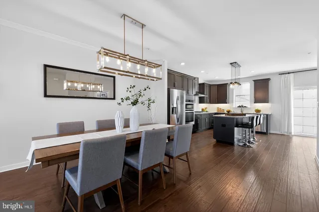 a view of a dining room with furniture wooden floor and kitchen view