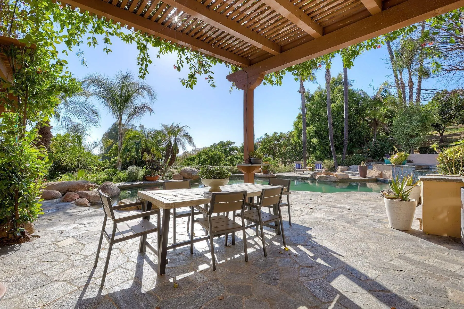 3993 Peony Drive Fallbrook, CA 92028 - Photo 26 of 52 a view of a patio with table and chairs and potted plants