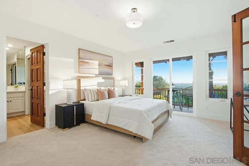 3993 Peony Drive Fallbrook, CA 92028 - Photo 34 of 52 a bedroom with a bed and large window
