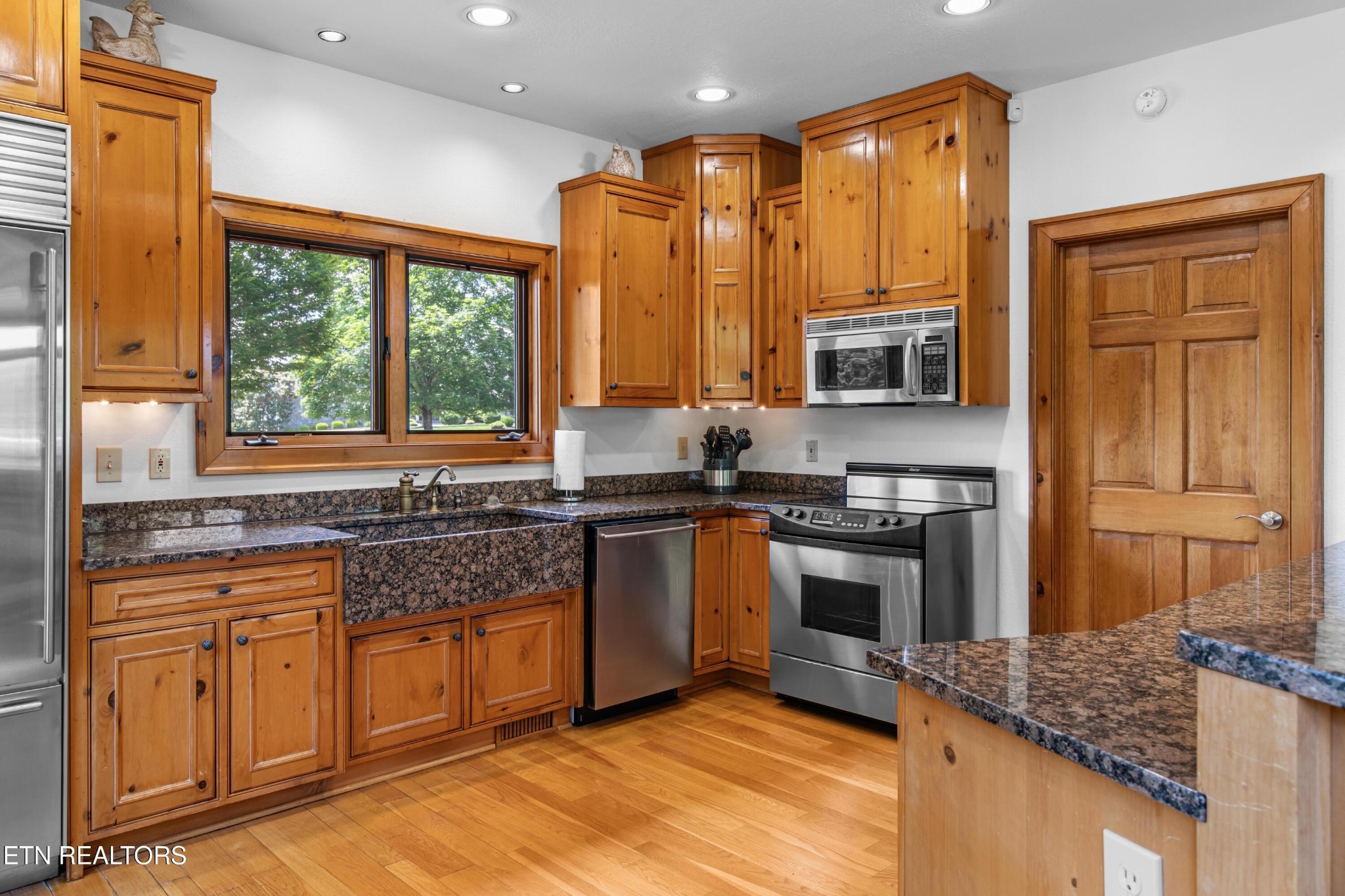 36 Thunder Ridge Drive Vonore, TN 37885 - Photo 12 of 30 a kitchen with stainless steel appliances granite countertop a stove a sink and a microwave