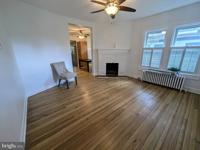 a view of livingroom with furniture fireplace and wooden floor
