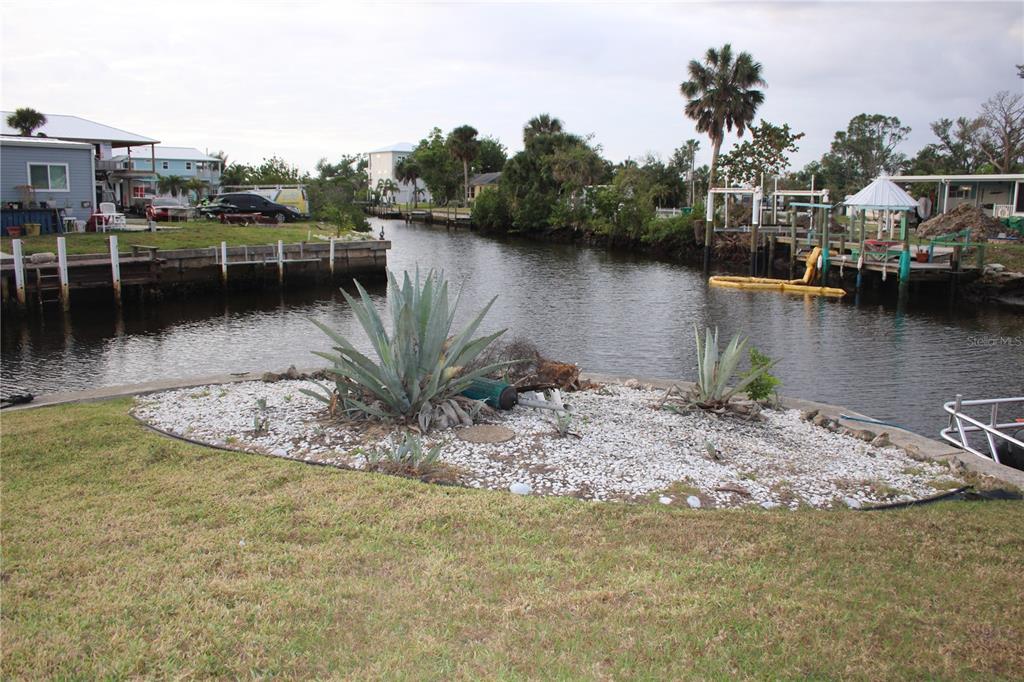 a view of a lake with boats and trees in the background
