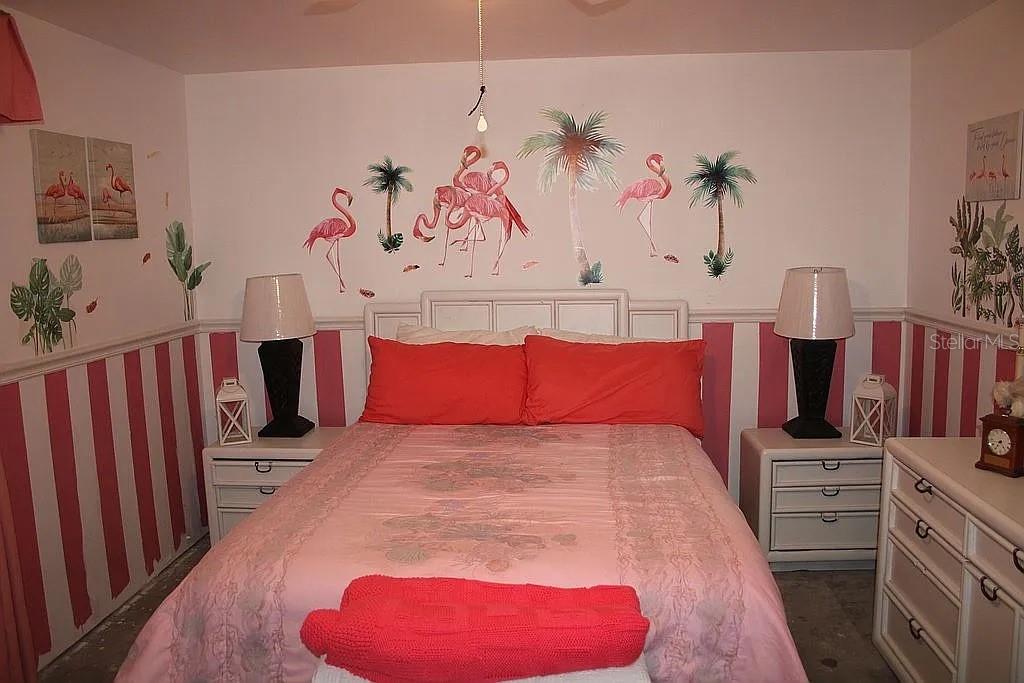 4252 Bardot Road Port Charlotte, FL 33953 - Photo 12 of 17 a bed room with a bed and a chair