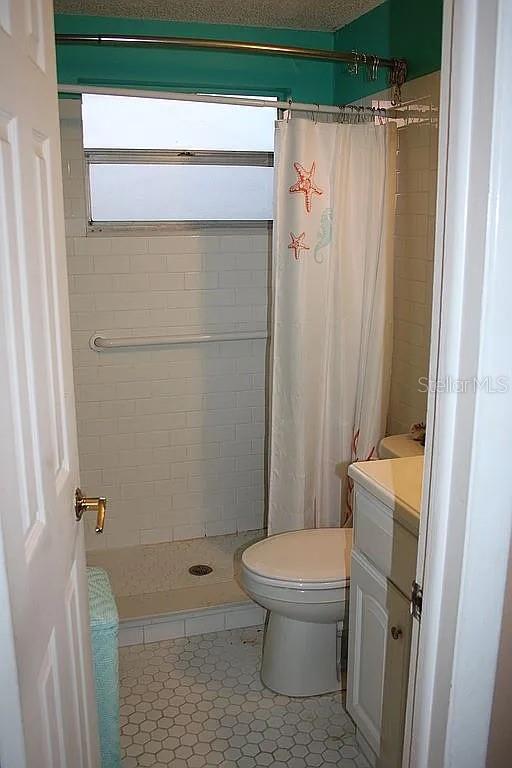4252 Bardot Road Port Charlotte, FL 33953 - Photo 14 of 17 a bathroom with a toilet and a shower