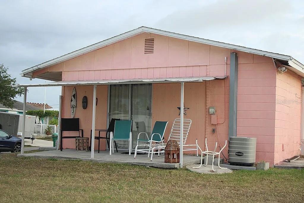 4252 Bardot Road Port Charlotte, FL 33953 - Photo 17 of 17 a backyard of a house with barbeque oven table and chairs