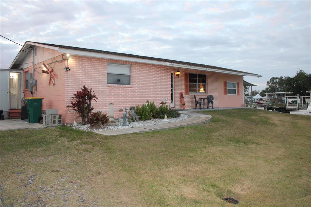 4252 Bardot Road Port Charlotte, FL 33953 - Photo 2 of 17 a front view of a house with garden
