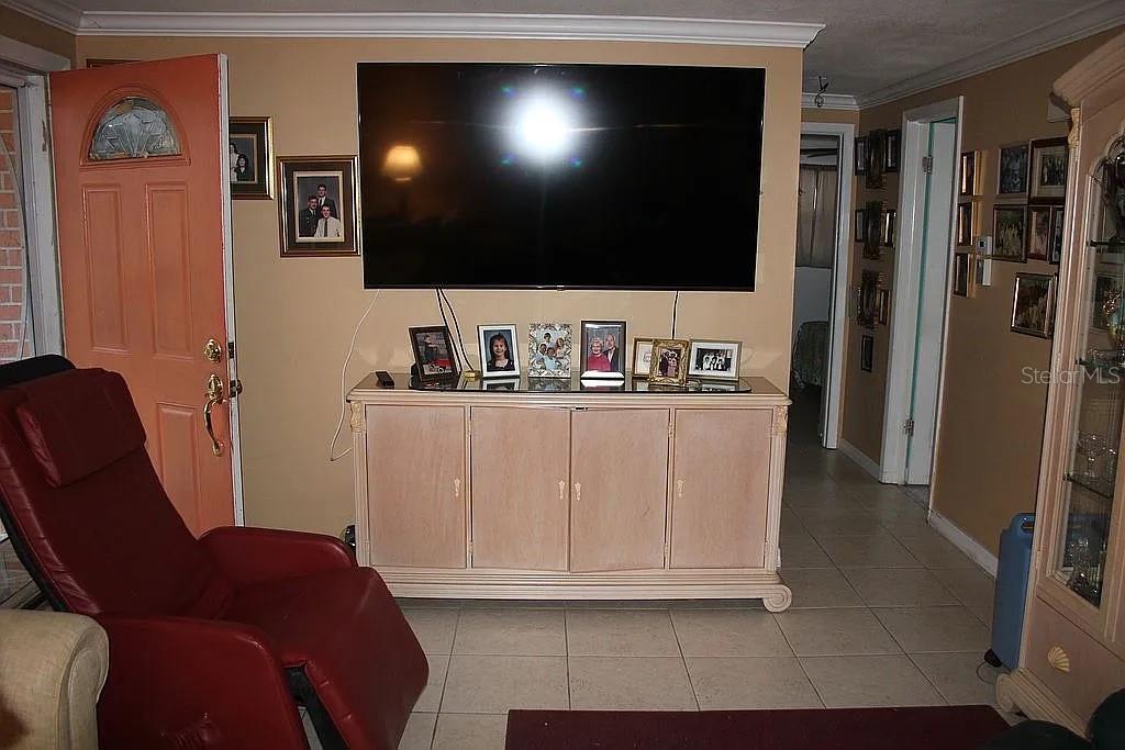 4252 Bardot Road Port Charlotte, FL 33953 - Photo 9 of 17 a living room with furniture and a flat screen tv