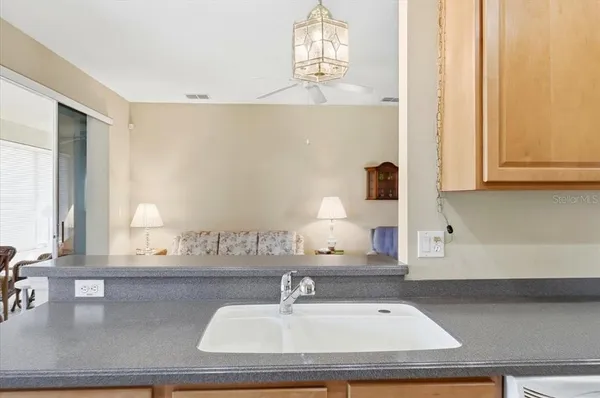 a kitchen with a stove a refrigerator and chairs