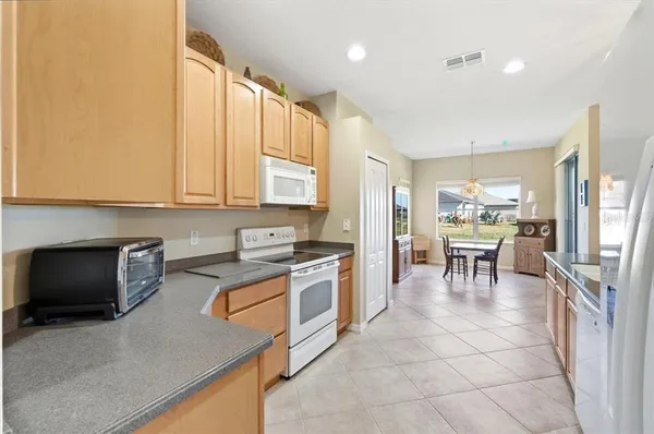 a view of a living room and kitchen with a large window