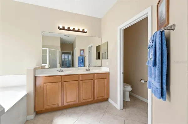 a view of an empty walk in closet with wooden floor