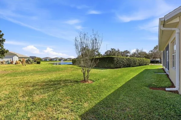 a living room with furniture a rug and a large window