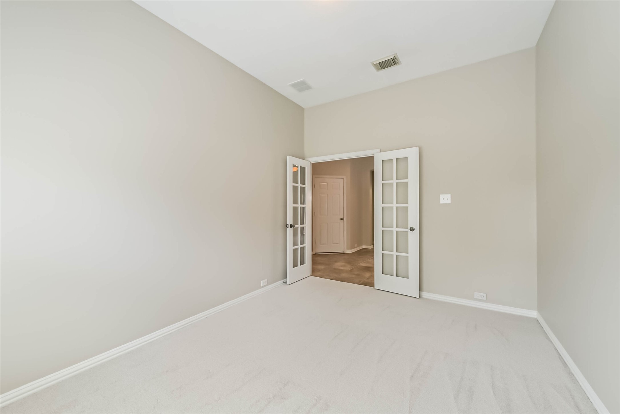 30910 Blue Ridge Park Lane Spring, TX 77386 - Photo 31 of 50 Bright and airy room featuring elegant French doors, soft carpet, and neutral walls, perfect for a cozy retreat or home office.