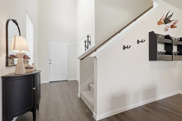 a view of a livingroom with wooden floor and staircase