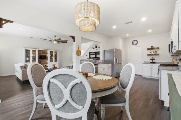 a dining room with furniture and wooden floor
