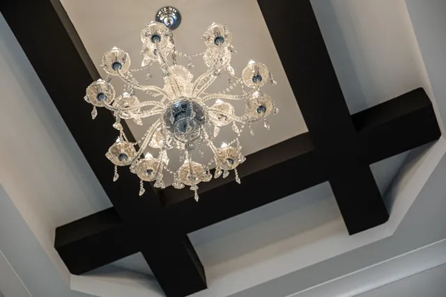 a vase of flowers sitting on a table with a mirror