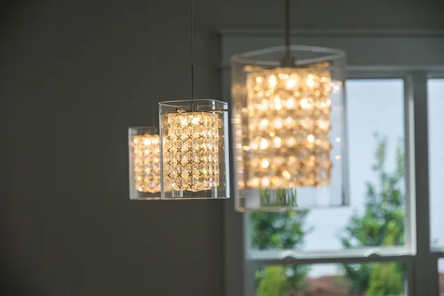 an empty room with wooden floor fireplace and windows
