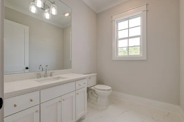 a bathroom with double sink shower and two mirror