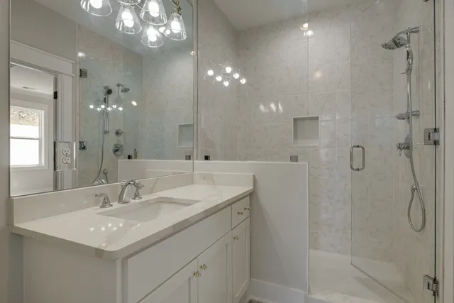 an aerial view of residential houses with outdoor space and trees