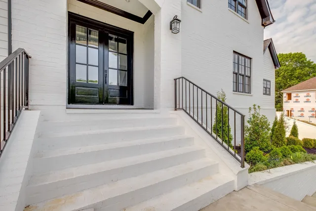 a view of staircase with white walls and windows