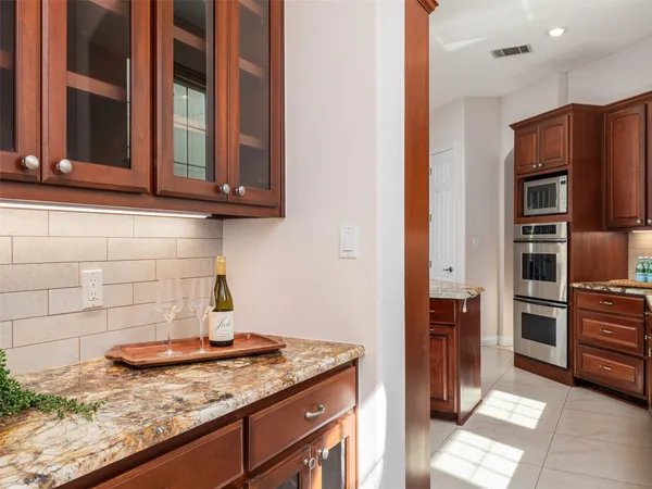 a kitchen with granite countertop cabinets and stainless steel appliances