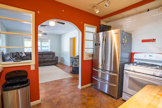186 West Center Street Moab, UT 84532 - Photo 7 of 15 Kitchen featuring a stainless steel French door refrigerator, white gas range, and wood-finish flooring