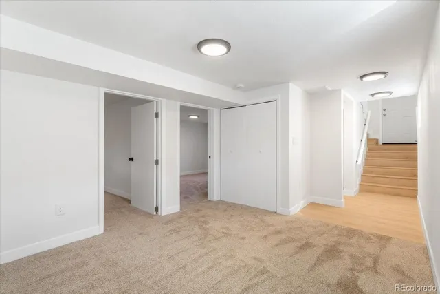 a view of a hallway with wooden shelves