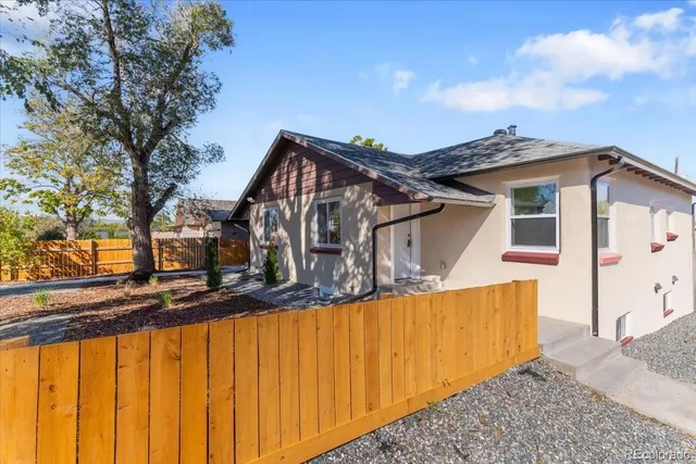 a front view of a house with wooden fence