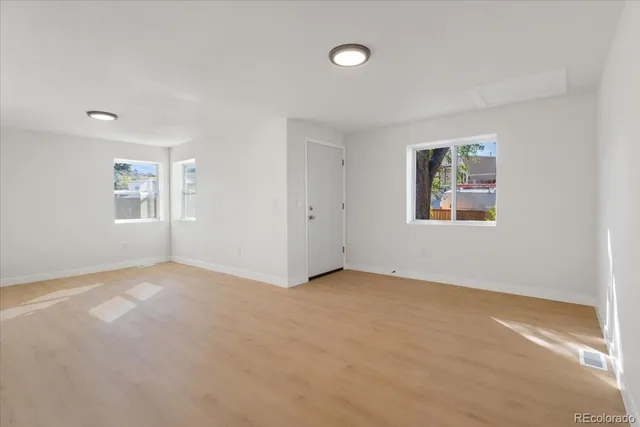 an empty room with windows and closet
