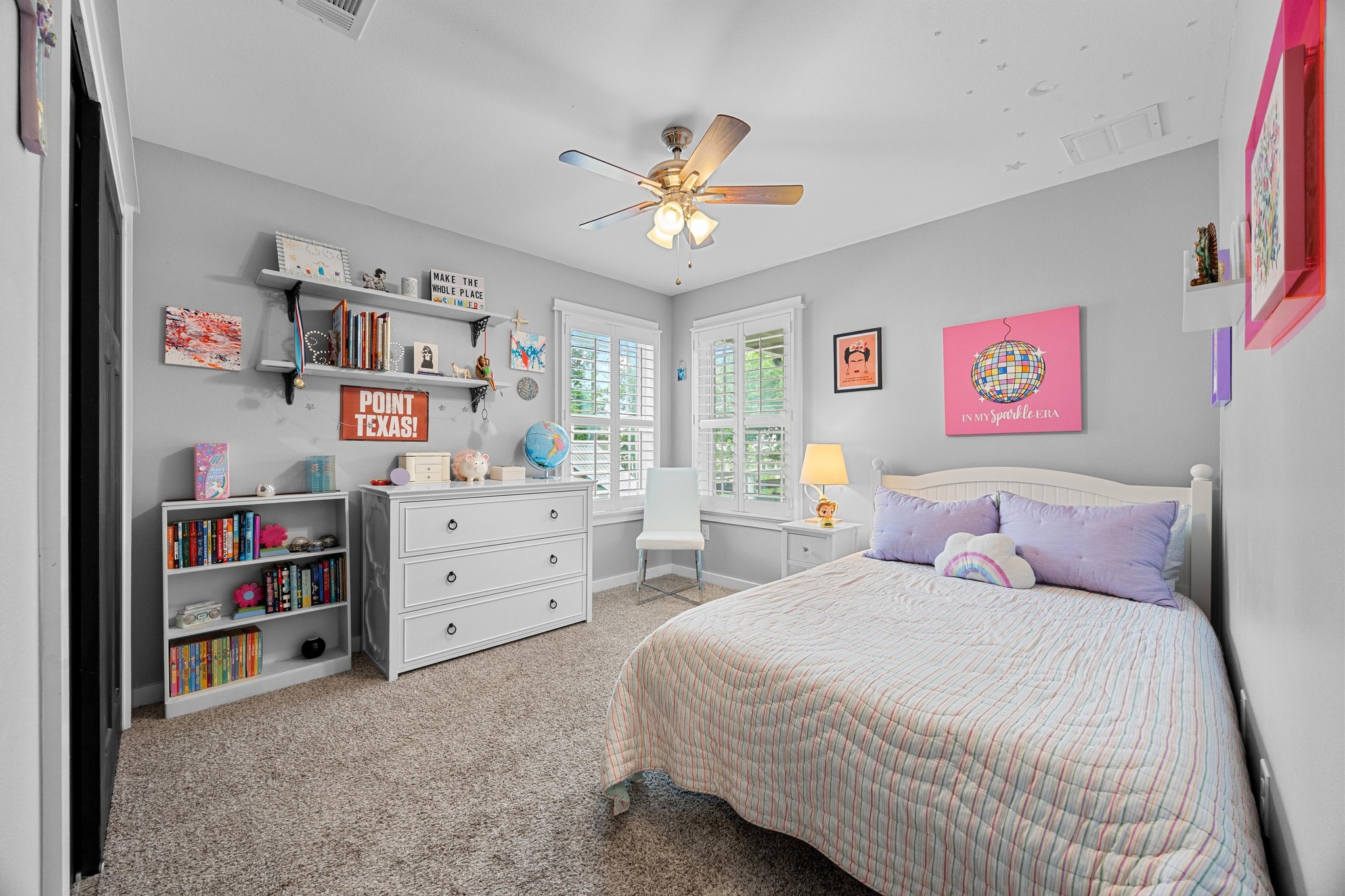 3907 Becker Avenue Austin, TX 78751 - Photo 24 of 37 Bedroom featuring custom shutters, light carpet and ceiling fan.