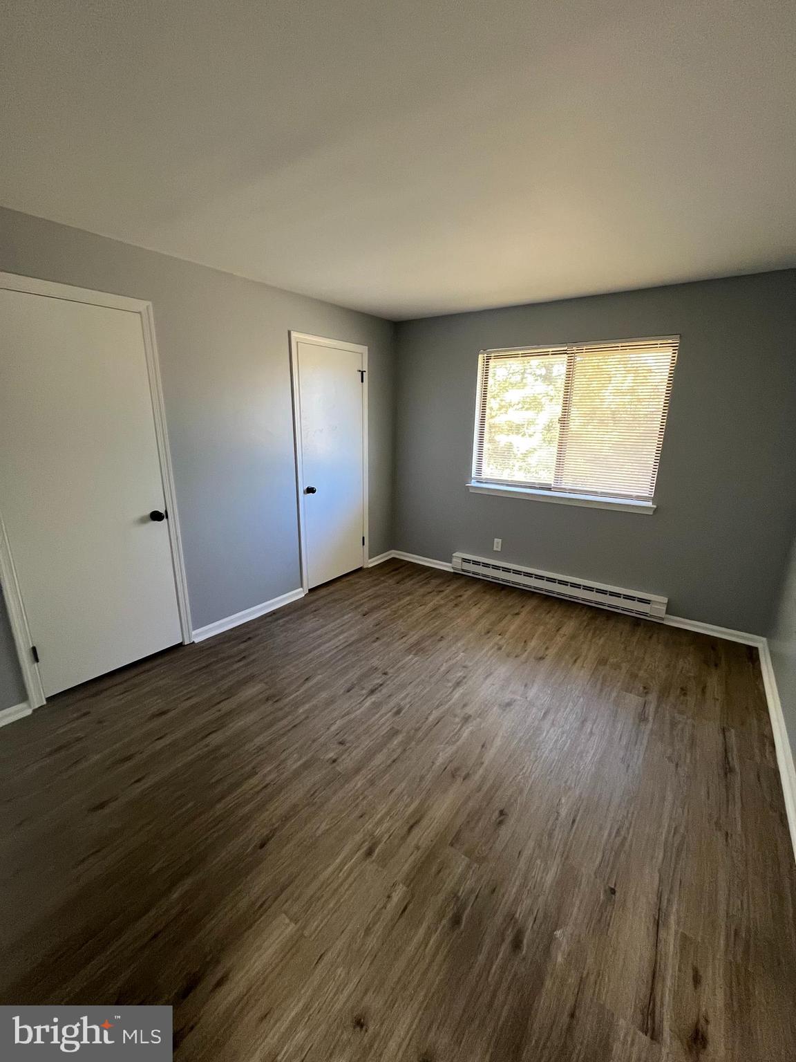 612 North Shady Retreat Road, Unit 14 Doylestown, PA 18901 - Photo 11 of 22 an empty room with wooden floor and windows