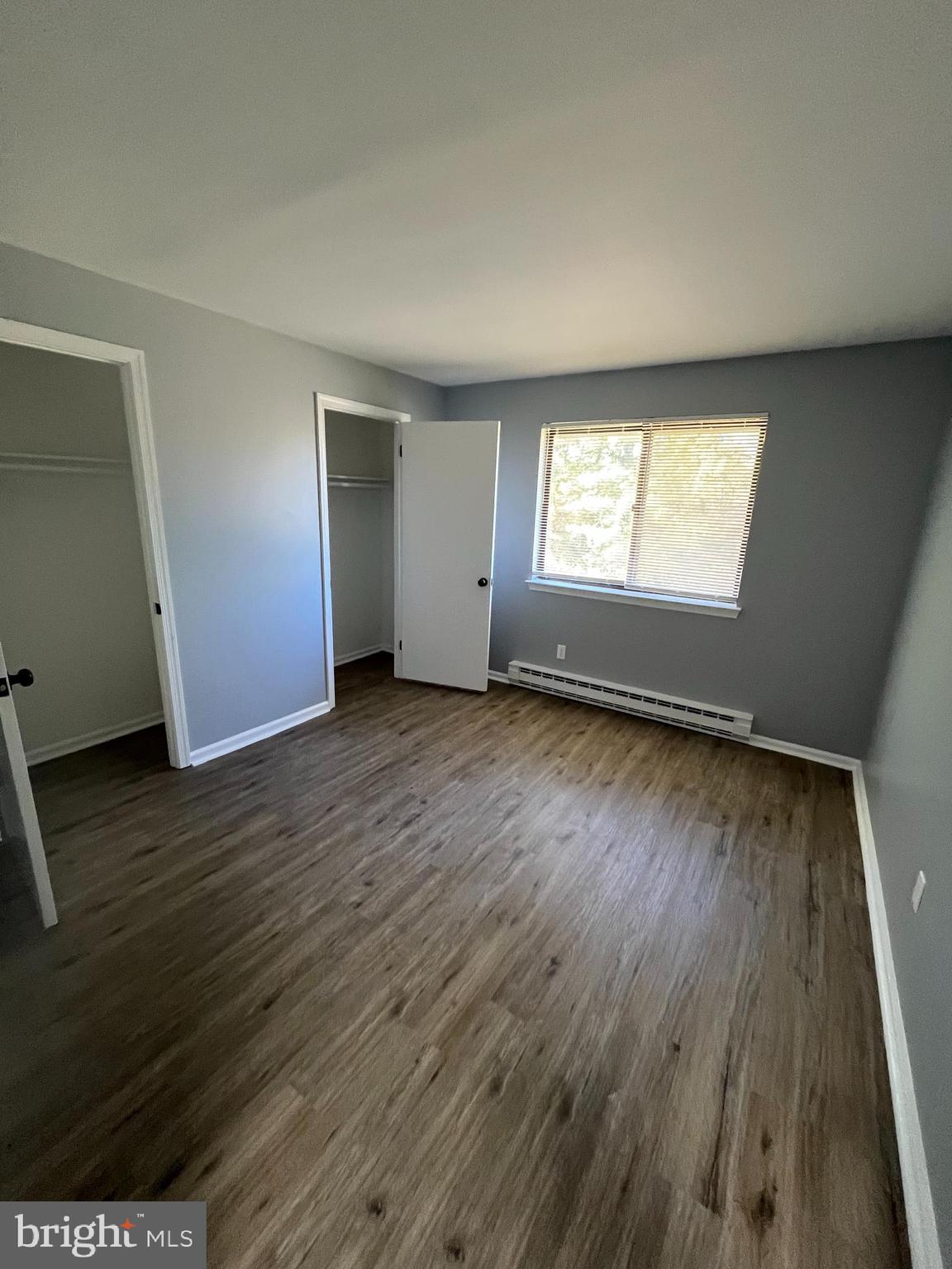 612 North Shady Retreat Road, Unit 14 Doylestown, PA 18901 - Photo 6 of 22 an empty room with wooden floor and windows