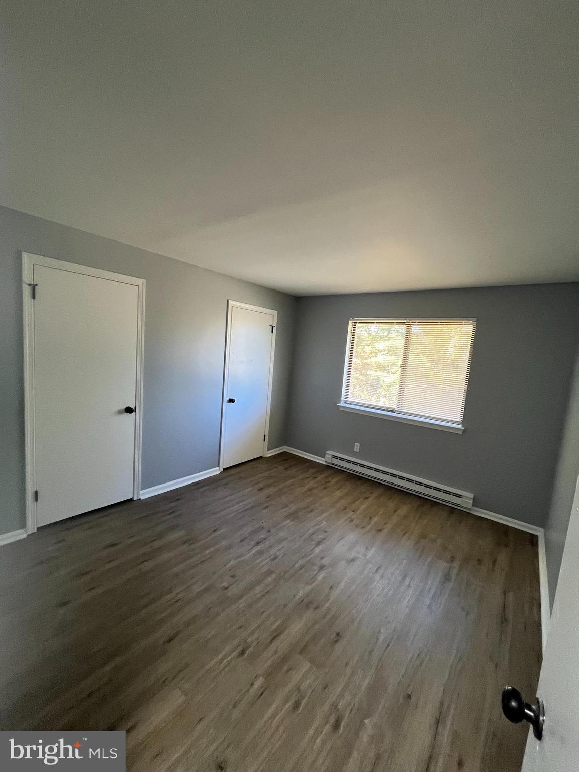 612 North Shady Retreat Road, Unit 14 Doylestown, PA 18901 - Photo 7 of 22 an empty room with wooden floor and windows