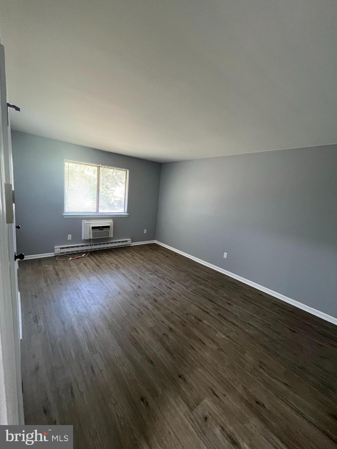 612 North Shady Retreat Road, Unit 14 Doylestown, PA 18901 - Photo 8 of 22 an empty room with wooden floor and windows
