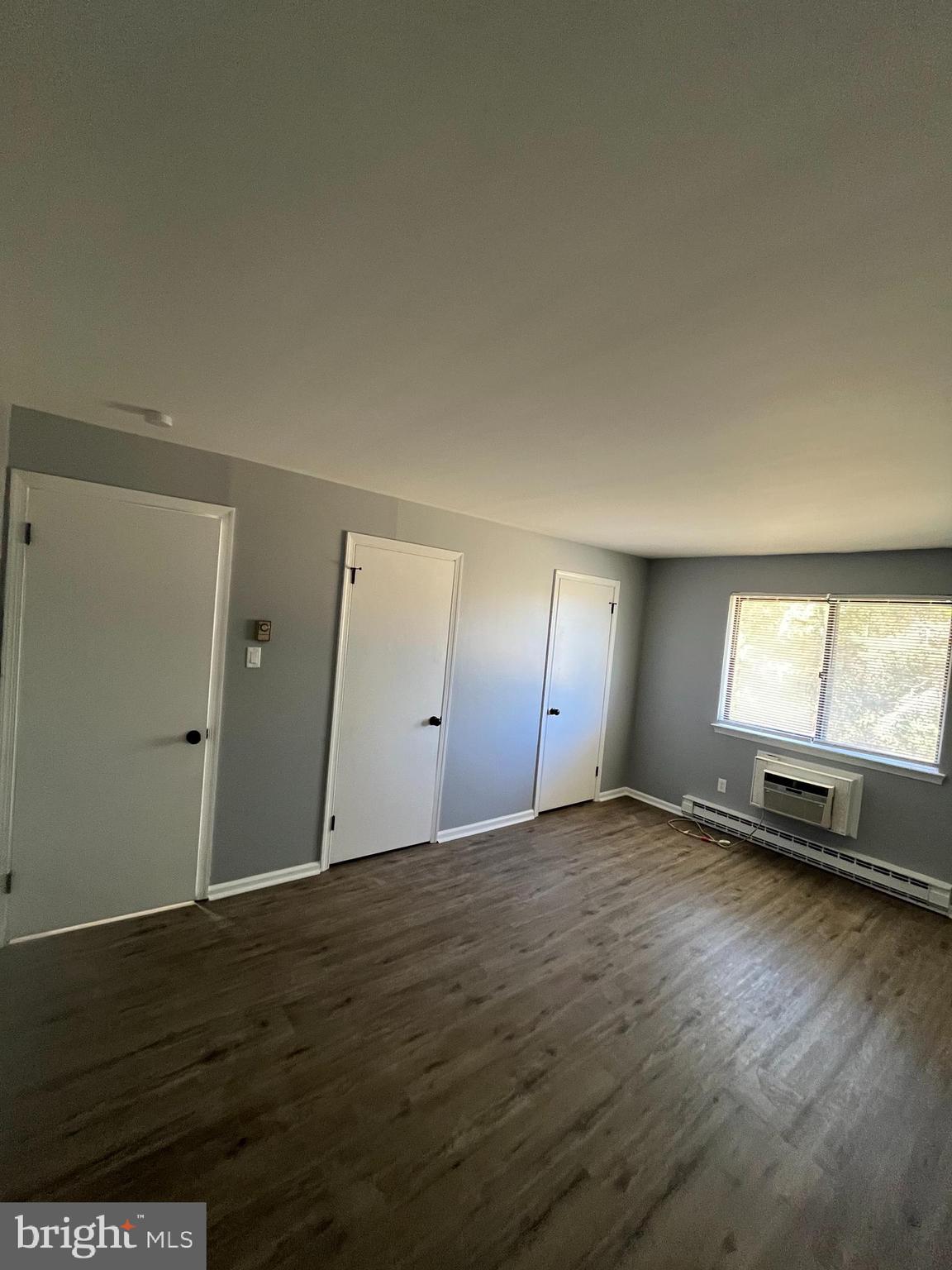 612 North Shady Retreat Road, Unit 14 Doylestown, PA 18901 - Photo 9 of 22 an empty room with wooden floor and windows