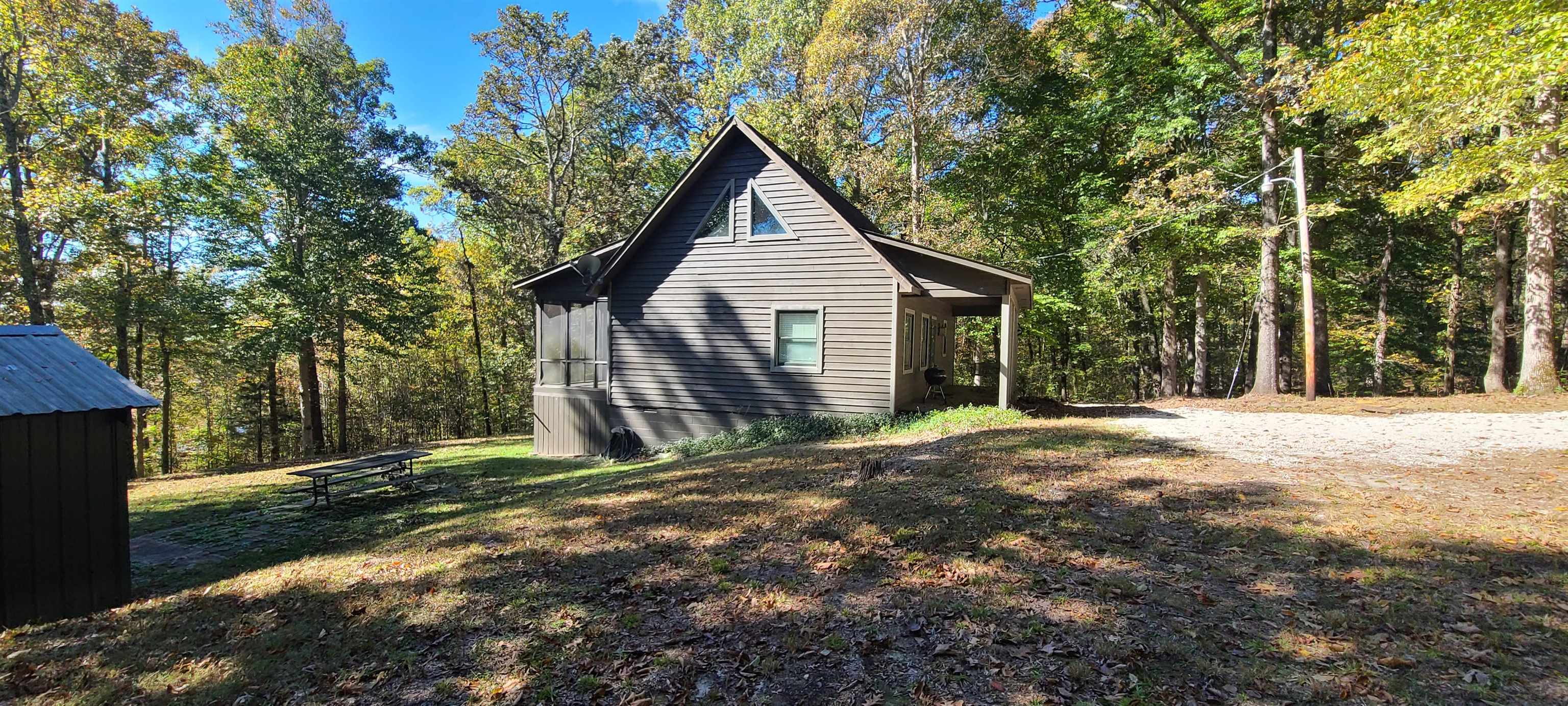 1548 Lakeview Manor Road Springville, TN 38256 - Photo 6 of 18 a front view of a house with a yard and garage