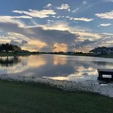 a view of a lake with houses in the back