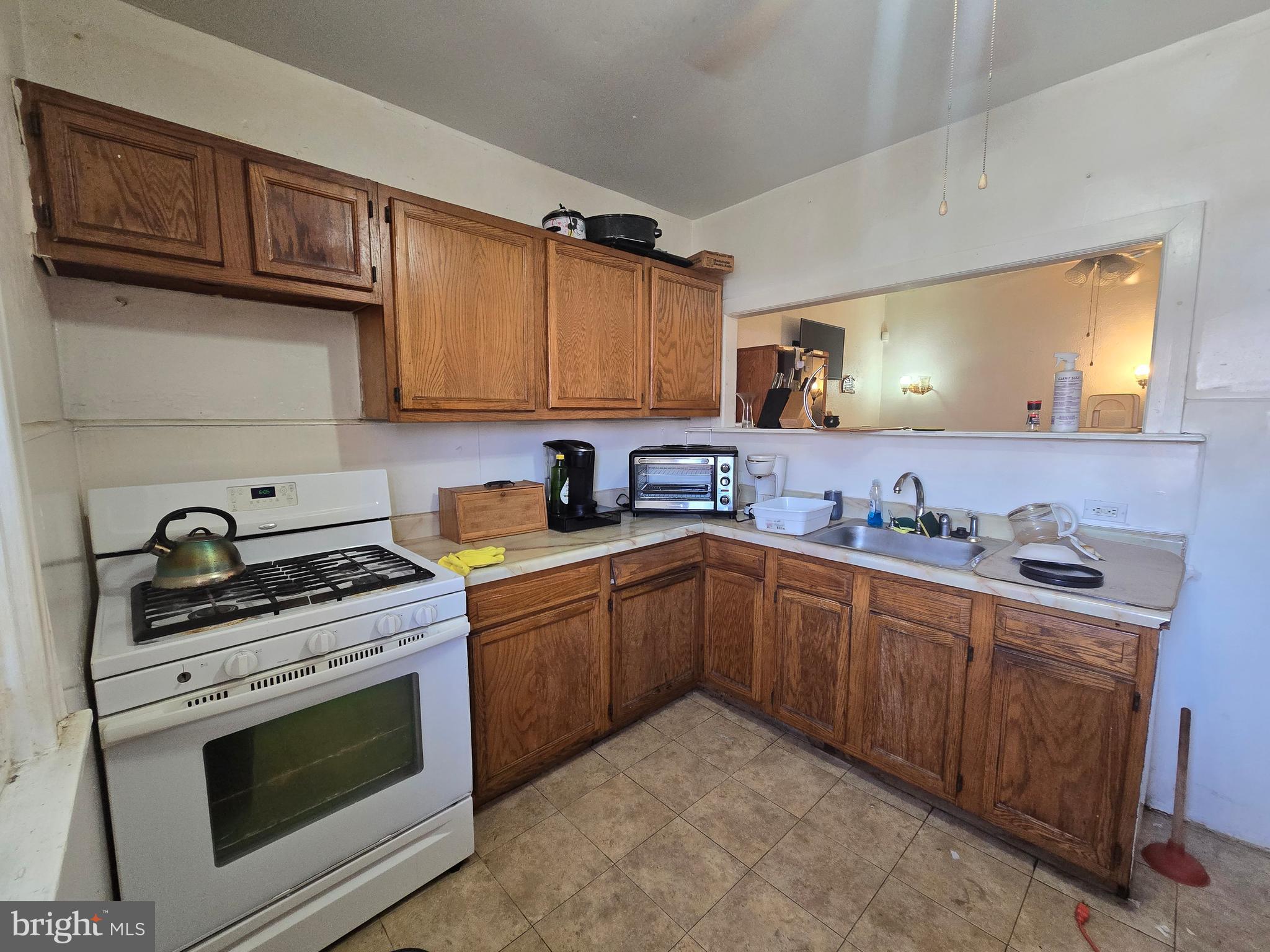 1959 Georgian Road Philadelphia, PA 19138 - Photo 14 of 29 a kitchen with granite countertop a stove sink and cabinets