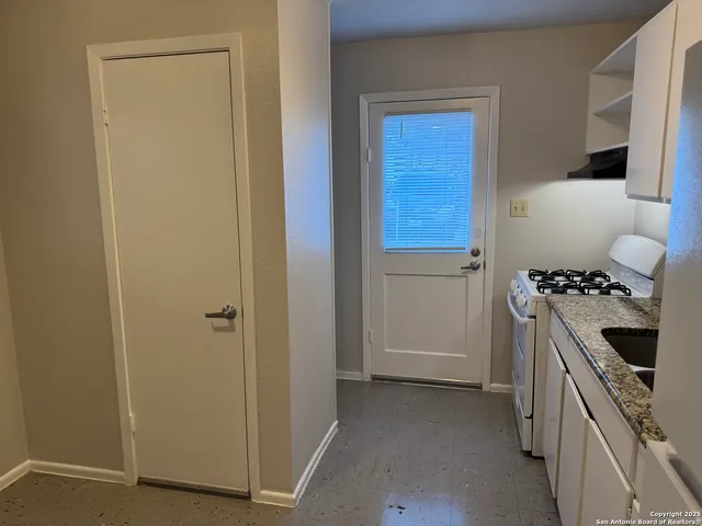 a kitchen with a stove and a refrigerator