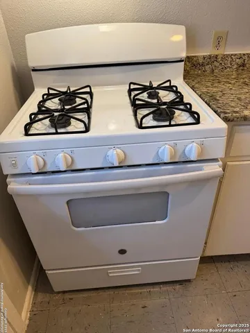 a stove top oven sitting inside of a kitchen