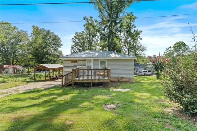 a view of a house with a yard porch and sitting area