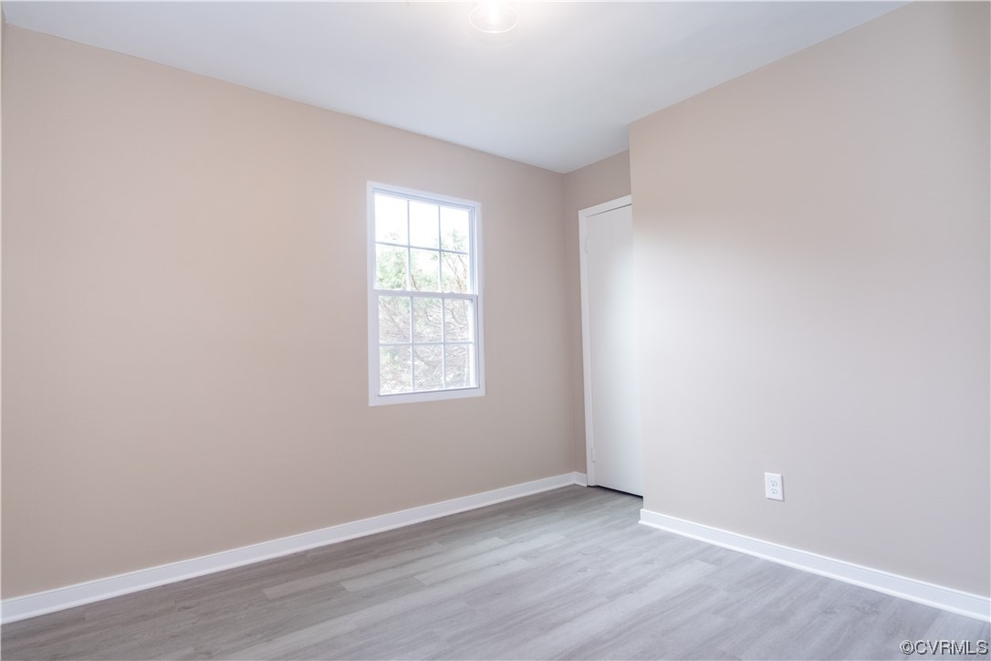 2307 Crosscreek Road Richmond, VA 23223 - Photo 12 of 14 an empty room with wooden floor and windows