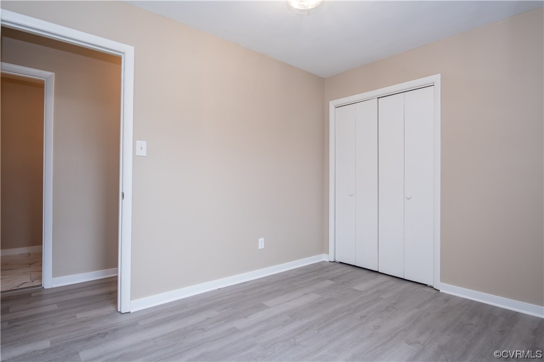 2307 Crosscreek Road Richmond, VA 23223 - Photo 13 of 14 a view of an empty room with wooden floor
