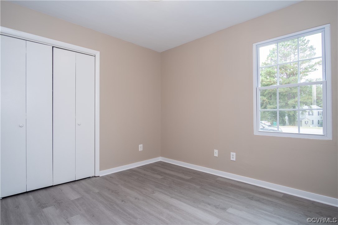 2307 Crosscreek Road Richmond, VA 23223 - Photo 14 of 14 a view of an empty room with wooden floor and a window