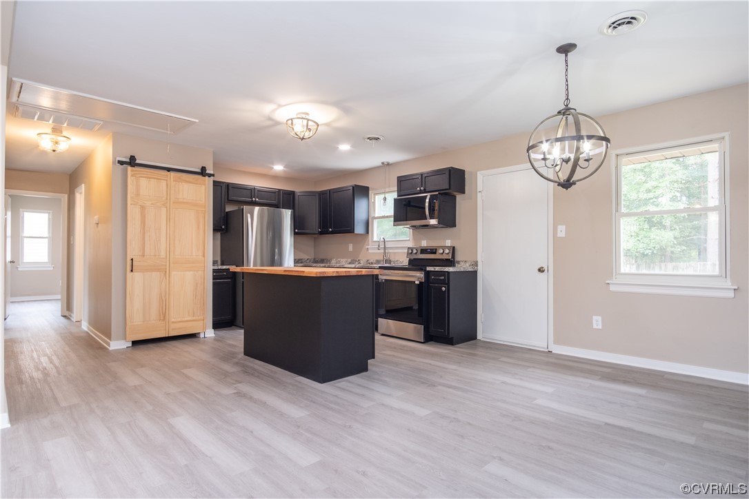 2307 Crosscreek Road Richmond, VA 23223 - Photo 3 of 14 a open kitchen with stainless steel appliances granite countertop a refrigerator a sink dishwasher a stove with wooden floor
