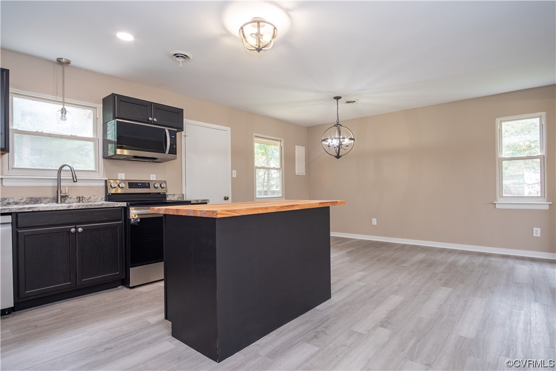 2307 Crosscreek Road Richmond, VA 23223 - Photo 4 of 14 a kitchen with granite countertop cabinets a sink and a wooden floor