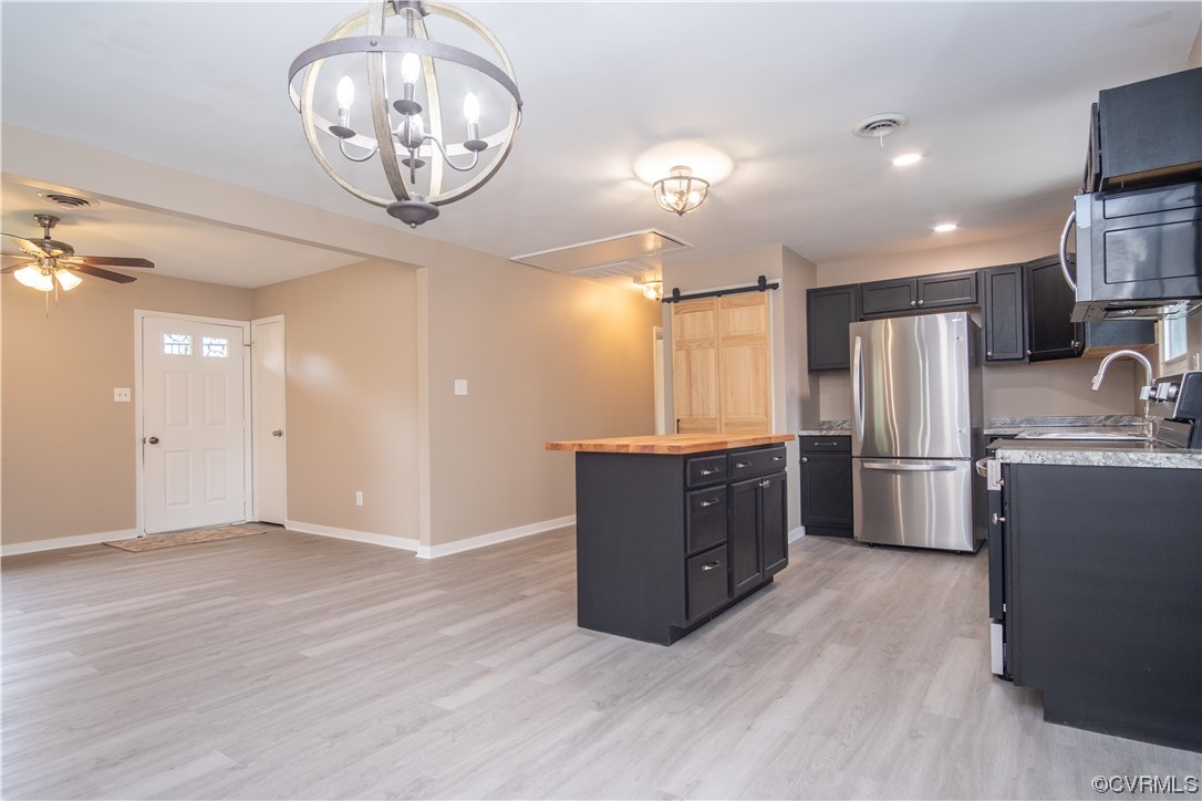 2307 Crosscreek Road Richmond, VA 23223 - Photo 5 of 14 a kitchen with stainless steel appliances a refrigerator and a chandelier